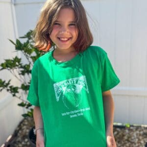 Smiling child in green t-shirt outdoors