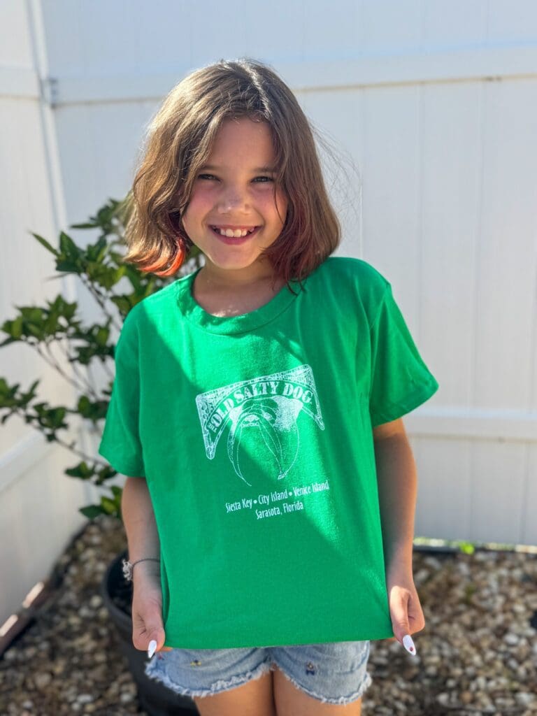 Smiling child in green t-shirt outdoors